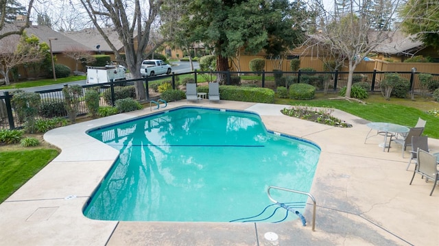 view of pool featuring a yard