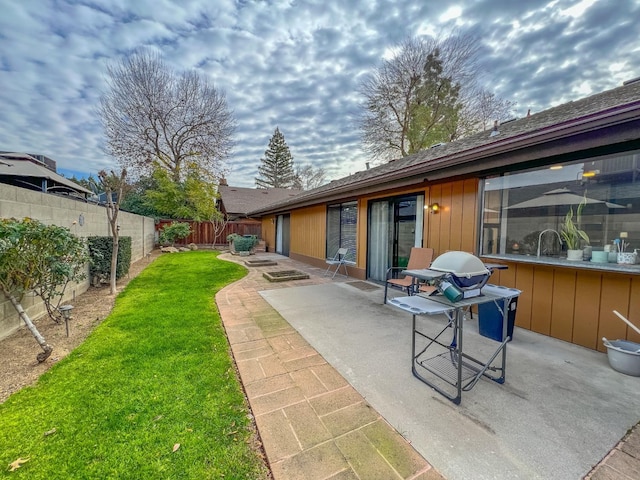 back of house with a yard and a patio area