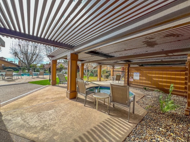 view of patio featuring a community pool and a pergola