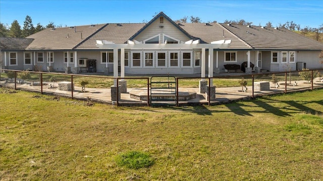 back of property featuring a lawn and a patio