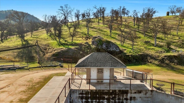 exterior space with a rural view and fence