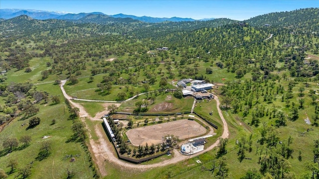 drone / aerial view with a wooded view and a mountain view