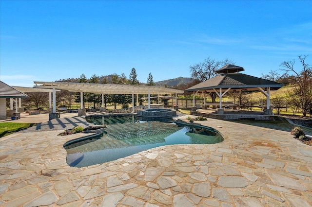 view of pool with a patio area, a gazebo, a pool with connected hot tub, and a pergola