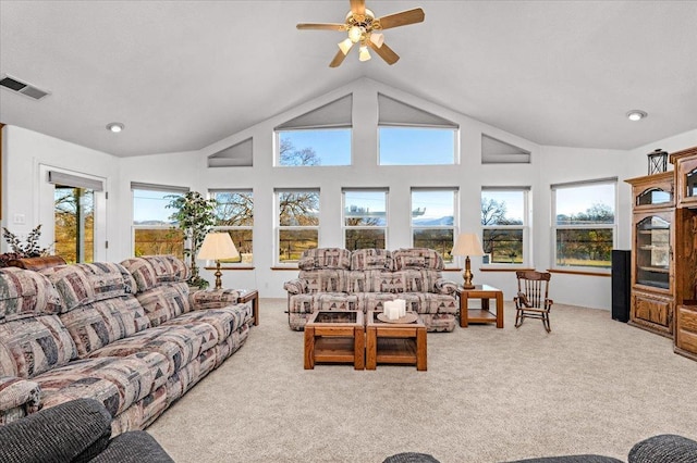 carpeted living room featuring ceiling fan and high vaulted ceiling