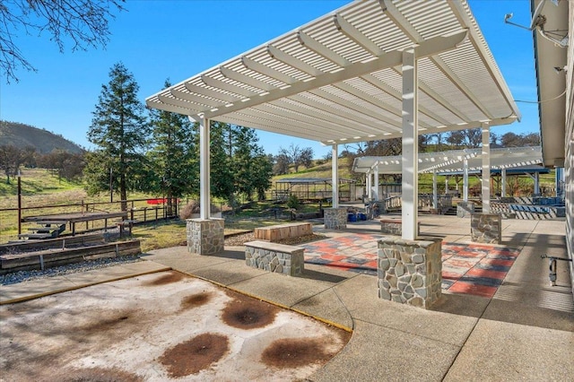 view of patio with a pergola and fence