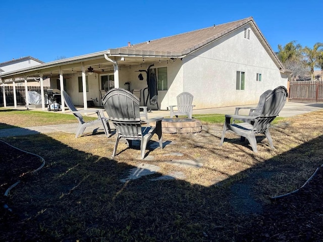 back of house featuring a patio area and an outdoor fire pit