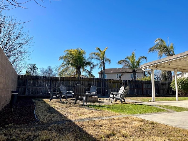 view of yard with a patio and a fire pit