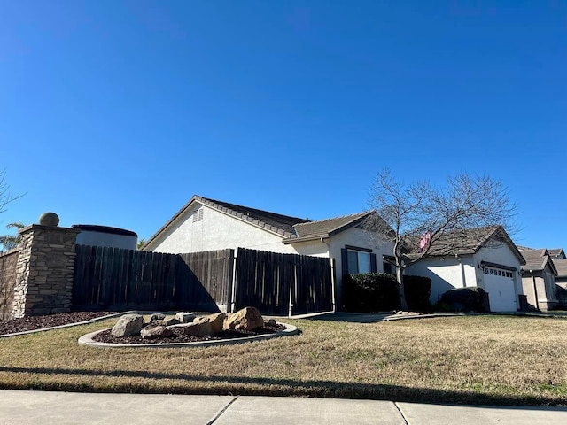 view of home's exterior featuring a yard and a garage