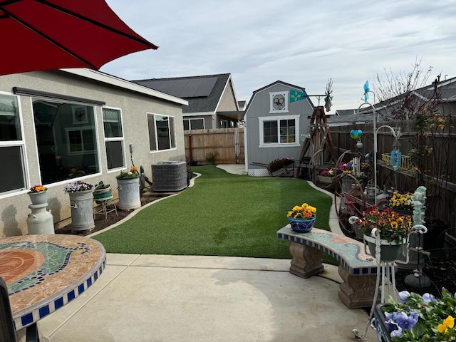 view of yard with cooling unit, a patio area, and a shed