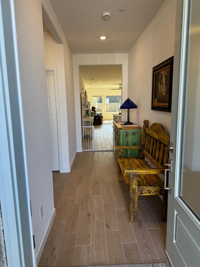 hall with recessed lighting, baseboards, and wood tiled floor