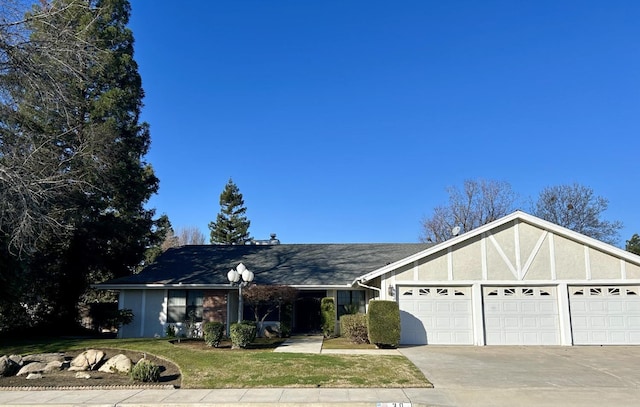 ranch-style house featuring a garage and a front yard