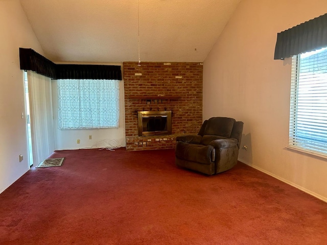 unfurnished living room with lofted ceiling, carpet, and a brick fireplace