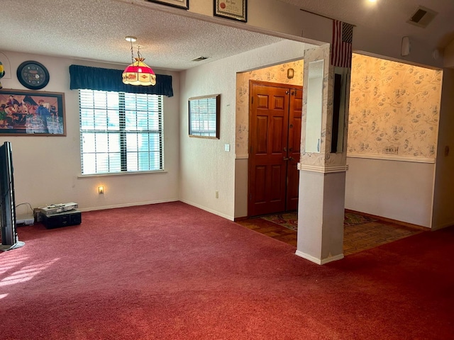 interior space featuring a textured ceiling and dark carpet