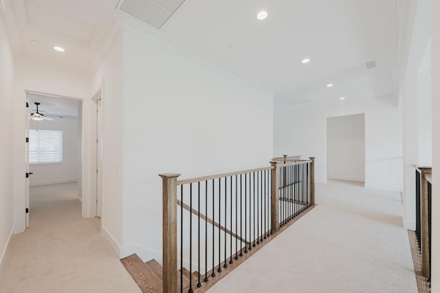 corridor featuring ornamental molding and light carpet