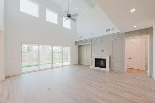 unfurnished living room featuring ceiling fan and light hardwood / wood-style floors