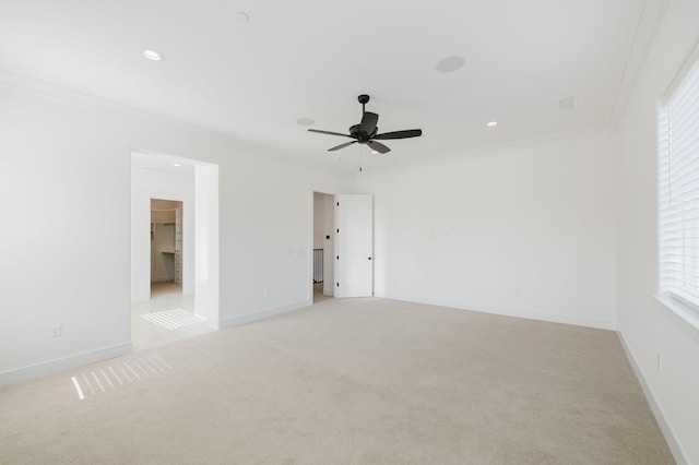 carpeted empty room featuring ornamental molding and ceiling fan