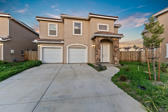 mediterranean / spanish-style home with a garage