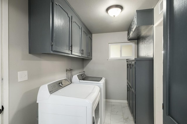 laundry area featuring visible vents, marble finish floor, baseboards, cabinet space, and independent washer and dryer