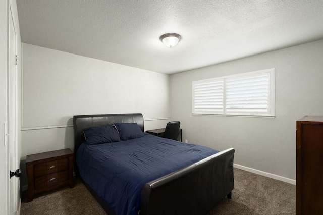 bedroom with carpet floors, a textured ceiling, and baseboards