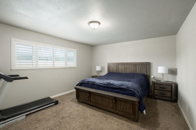 bedroom featuring carpet floors, a textured ceiling, and baseboards