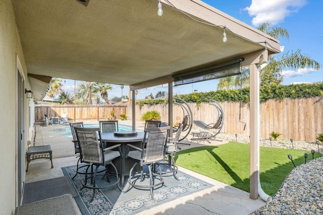 view of patio / terrace featuring a fenced in pool, outdoor dining area, and a fenced backyard