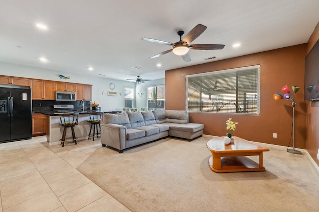 tiled living room with sink and ceiling fan