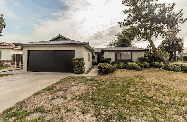 ranch-style home featuring a garage and a front lawn