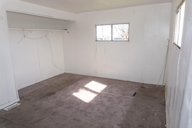 empty room with carpet flooring and visible vents