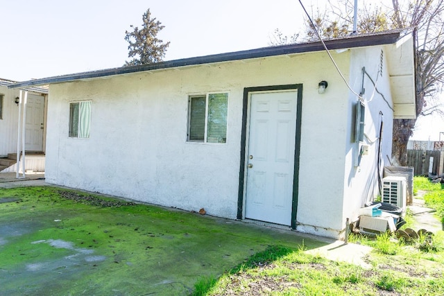 rear view of property with stucco siding