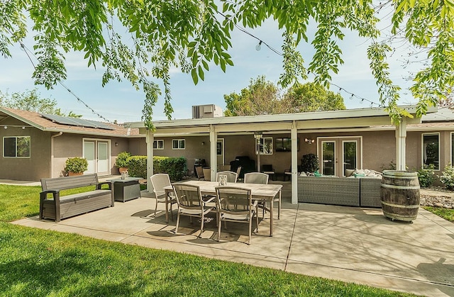 16526 Paula Rd, Madera, CA 93636 - rear view of house featuring an outdoor hangout area, stucco siding, a patio, solar panels, and outdoor dining area