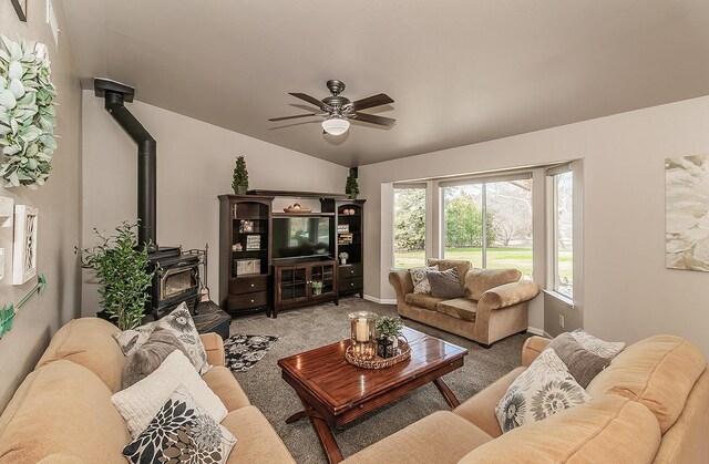 16526 Paula Rd, Madera, CA 93636 - carpeted living room with a wood stove, baseboards, vaulted ceiling, and ceiling fan