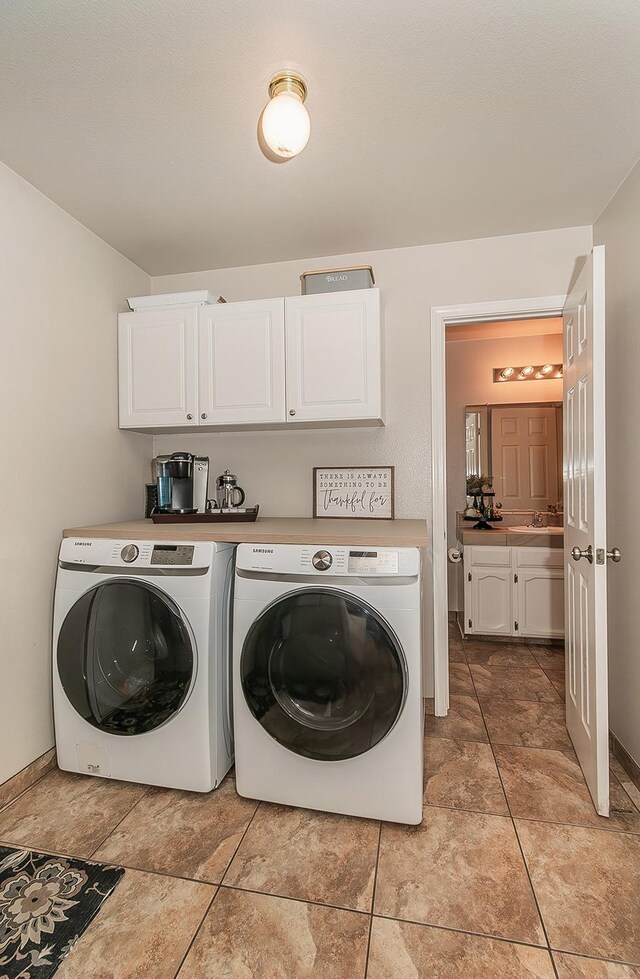 16526 Paula Rd, Madera, CA 93636 - clothes washing area with independent washer and dryer, baseboards, a sink, and cabinet space