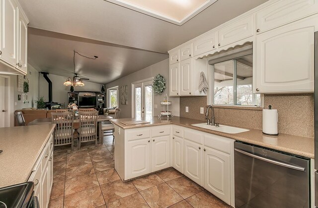 16526 Paula Rd, Madera, CA 93636 - kitchen with dishwasher, a sink, open floor plan, a wood stove, and range