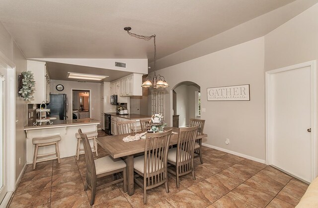 16526 Paula Rd, Madera, CA 93636 - dining area with a notable chandelier, baseboards, visible vents, lofted ceiling, and arched walkways