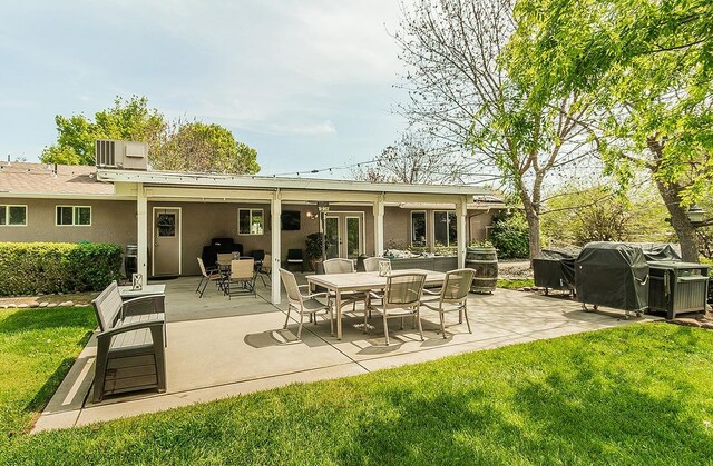 16526 Paula Rd, Madera, CA 93636 - rear view of house featuring cooling unit, a patio, a lawn, and stucco siding