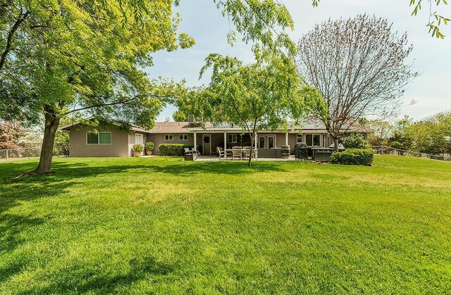 16526 Paula Rd, Madera, CA 93636 - rear view of house featuring an outdoor living space, a yard, stucco siding, a patio, and fence