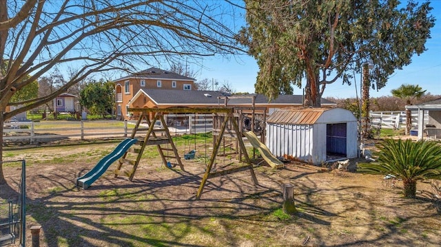 view of playground with a shed