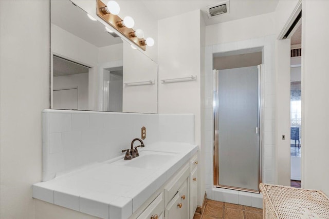 bathroom with vanity and a shower with shower door