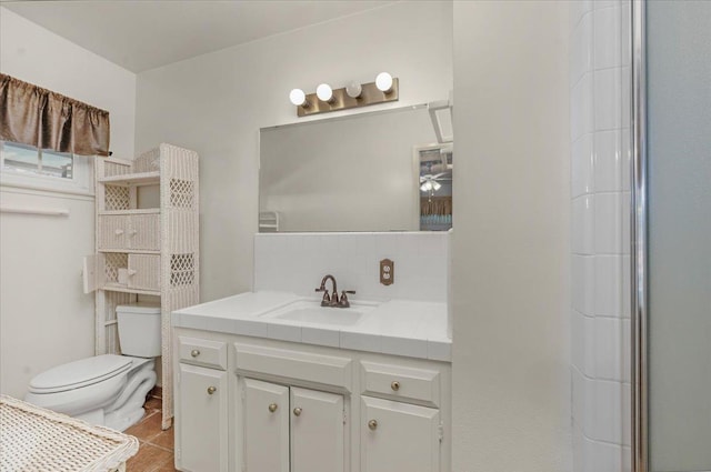 bathroom featuring tasteful backsplash, vanity, a shower, and toilet