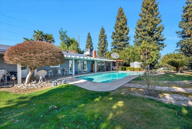 view of pool with a yard and a patio