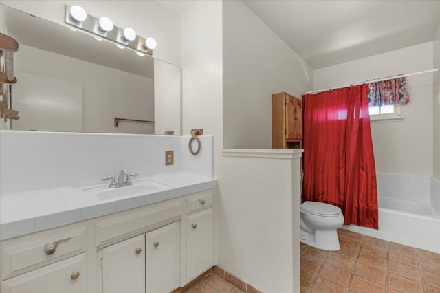 bathroom featuring vanity, backsplash, and toilet