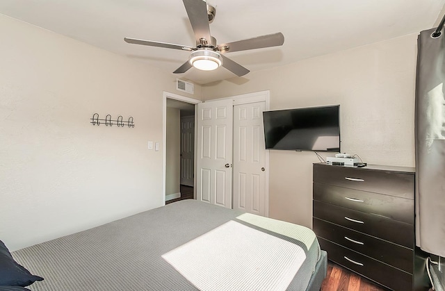 bedroom with ceiling fan and a closet