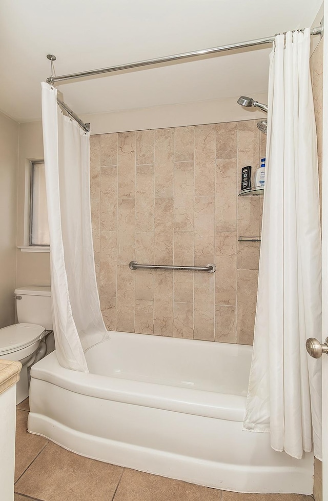 bathroom featuring toilet, tile patterned flooring, and shower / tub combo