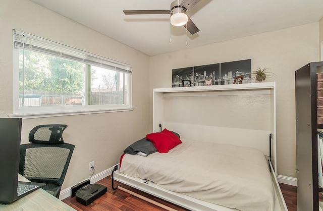 bedroom with hardwood / wood-style floors and ceiling fan