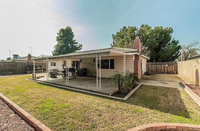 rear view of property with a patio and a yard