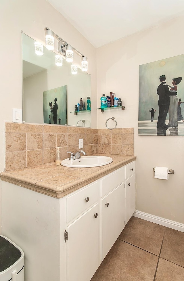 bathroom with tasteful backsplash, vanity, and tile patterned floors