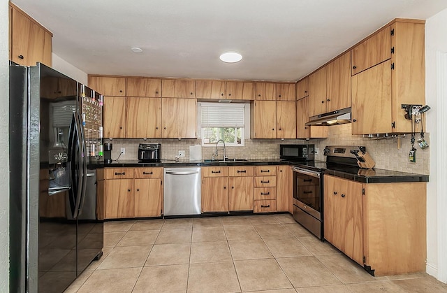 kitchen featuring sink, light tile patterned floors, decorative backsplash, and black appliances