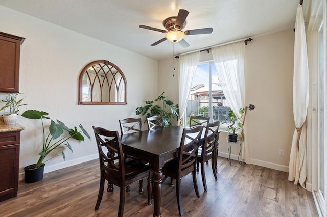 dining space with ceiling fan and dark hardwood / wood-style floors