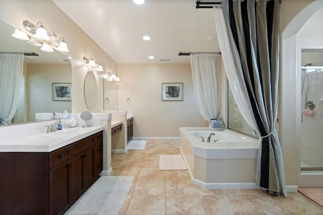 bathroom featuring tile patterned floors, separate shower and tub, and vanity