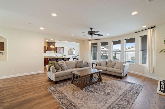 living room featuring dark hardwood / wood-style floors and ceiling fan